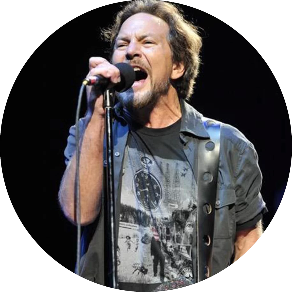 Eddie Vedder wearing an Underground Faction t-shirt with the design Decline on the front while singing on stage.