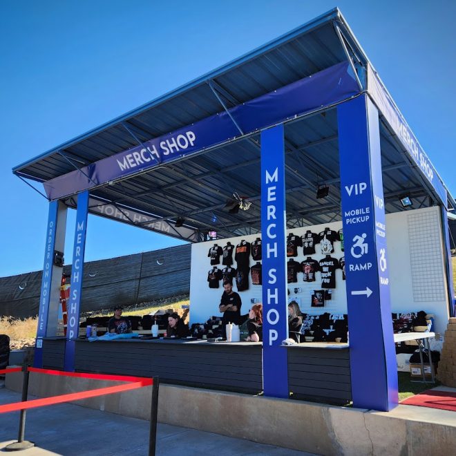 Merch booth at Talking Stick Resort Amphitheatre. Features printed banners and vinyl graphics.