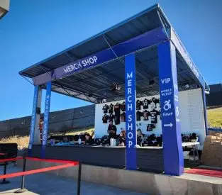 Merch booth at Talking Stick Resort Amphitheatre. Features printed banners and vinyl graphics.